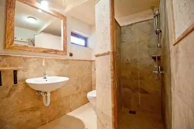 a bathroom with a sink and a toilet and a mirror at Medin di Lastua in Petrovac na Moru