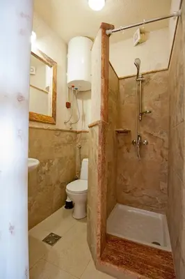 a bathroom with a shower with a toilet and a sink at Medin di Lastua in Petrovac na Moru