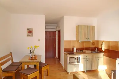 a kitchen with a table and a dining room at Loki Apartments in Kotor