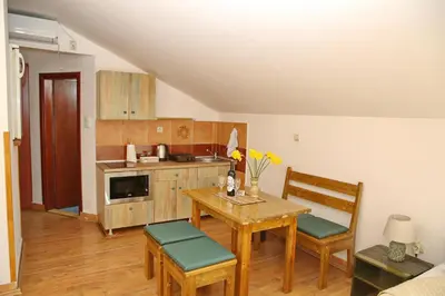 a kitchen with a table and two chairs and a table at Loki Apartments in Kotor