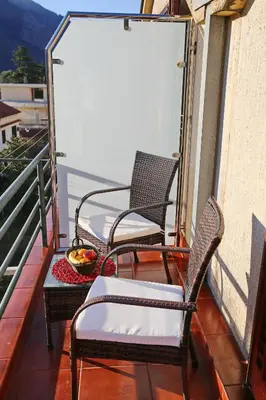 two chairs and a table on a balcony at Loki Apartments in Kotor