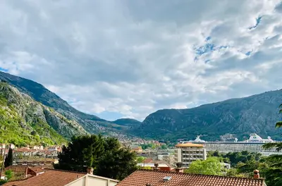 a view of a city with mountains in the background at Loki Apartments in Kotor