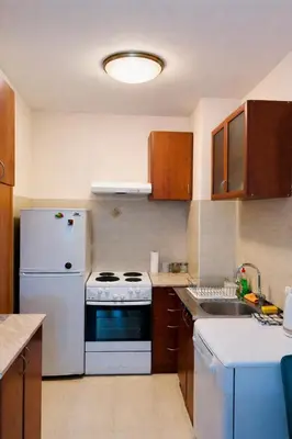 a kitchen with a white stove and a refrigerator at Apartment Flat in Podgorica