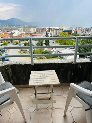 a table and chairs on a balcony with a view at Apartment Flat in Podgorica