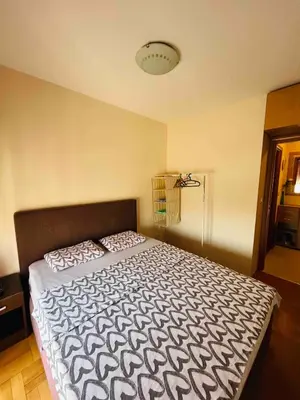 a bedroom with a bed with a black and white comforter at Apartment Flat in Podgorica