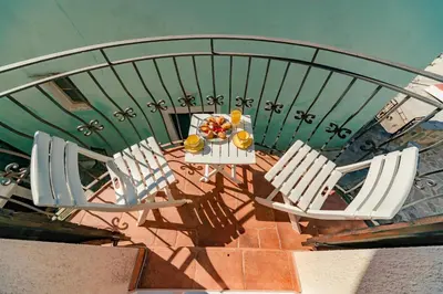 an overhead view of a table with chairs and a bowl of fruit at Apartments Bigovo Veljic in Tivat