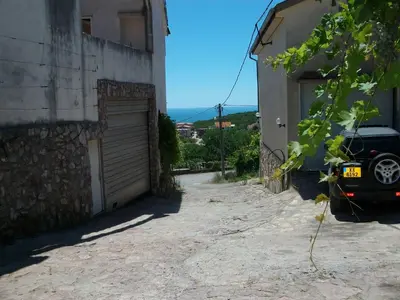 a car parked next to a building with a garage at Apartments Petrovic in Krimovice