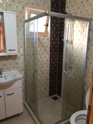 a shower with a glass door in a bathroom at Casa Mila apartments & bungalows in Ulcinj