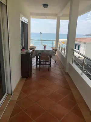 a balcony with a table and a view of the ocean at Casa Mila apartments & bungalows in Ulcinj
