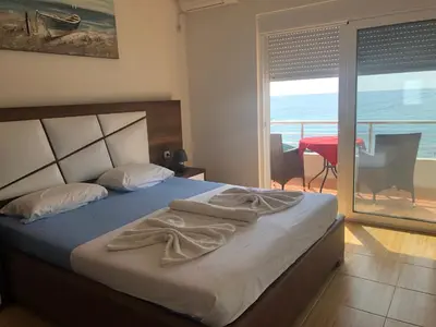 a bedroom with a bed with a view of the ocean at Casa Mila apartments & bungalows in Ulcinj
