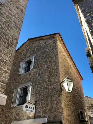 a tall brick building with a sign on it at Apartment Viva in Budva