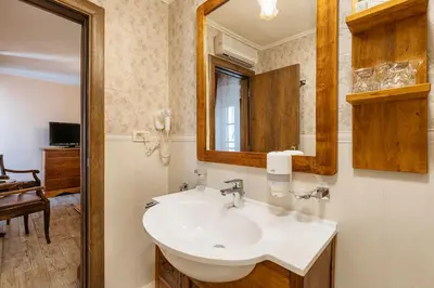 a bathroom with a sink and a mirror at Hotel Monte Cristo in Kotor