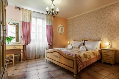 a bedroom with a bed and a dresser and a mirror at Hotel Monte Cristo in Kotor