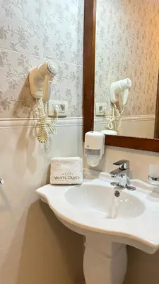 a bathroom with a sink and a mirror at Hotel Monte Cristo in Kotor