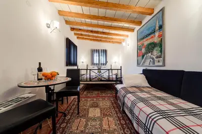 a living room with a couch and a table at Oasis Seaside Rooms in Budva