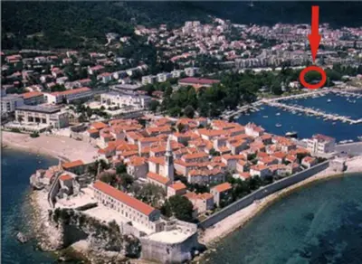 an aerial view of a city with a red arrow at Oasis Seaside Rooms in Budva