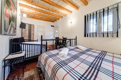 a bedroom with a bed and a crib in a room at Oasis Seaside Rooms in Budva