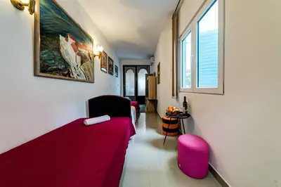 a room with a bed and two chairs and a window at Oasis Seaside Rooms in Budva