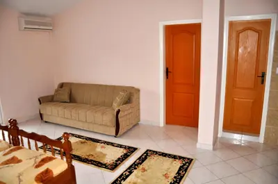 a living room with a couch and a door at Apartments Perezaj in Ulcinj