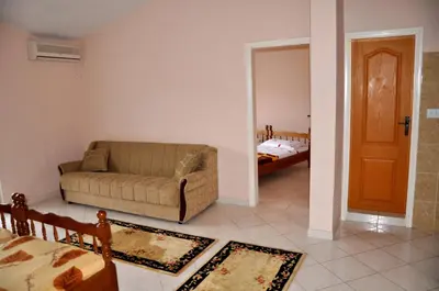 a living room with a couch and a bedroom at Apartments Perezaj in Ulcinj