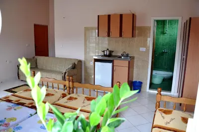 a living room with a couch and a kitchen at Apartments Perezaj in Ulcinj