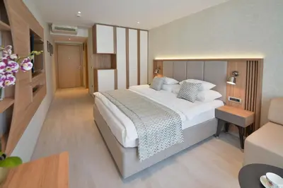 a bedroom with a large bed in a room at Mediteran Hotel & Resort in Budva