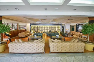 a lobby of a hotel with couches and tables at Mediteran Hotel & Resort in Budva