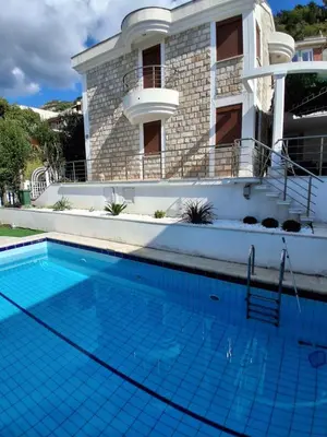 a large swimming pool in front of a house at Budva City - Villa Antic - Private Pool in Budva