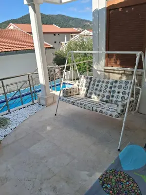 a bed on the balcony of a house at Budva City - Villa Antic - Private Pool in Budva