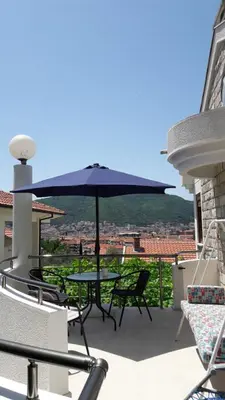 a patio with a table and an umbrella at Budva City - Villa Antic - Private Pool in Budva