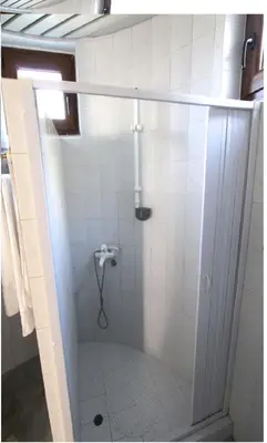 a shower stall in a bathroom with white tiles at Budva City - Villa Antic - Private Pool in Budva
