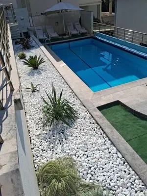 a swimming pool in a yard with rocks and plants at Budva City - Villa Antic - Private Pool in Budva