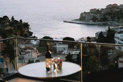 a group of people on a table looking at the water at Apartments Panorama Alaj in Ulcinj