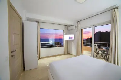 a bedroom with a bed and a balcony with a view at Apartments Panorama Alaj in Ulcinj