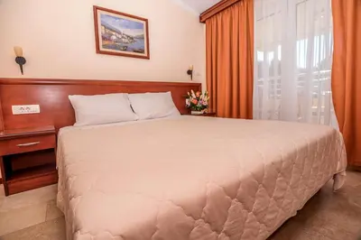 a bedroom with a large bed and a window at Villa Antivari in Bar
