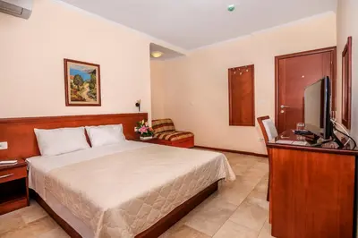a bedroom with a bed and a flat screen tv at Villa Antivari in Bar
