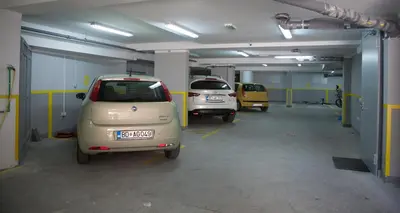 three small cars parked in a parking garage at Apia Residence in Budva