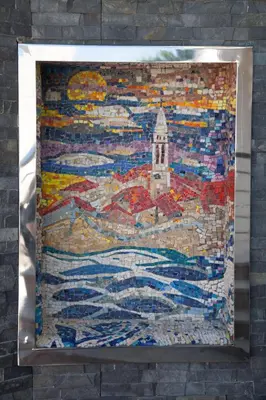 a mosaic painting of a lighthouse on a wall at Apia Residence in Budva
