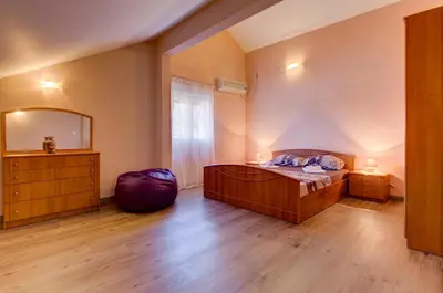 a bedroom with a bed and a large mirror at Apartments Vesna in Tivat