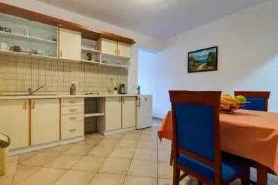 a kitchen with a table and a dining room at Apartments Vesna in Tivat