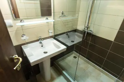 a bathroom with a sink and a shower at Apartments Vesna in Tivat