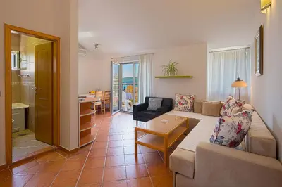 a living room with a couch and a table at Apartments Bloom Bečići in Becici