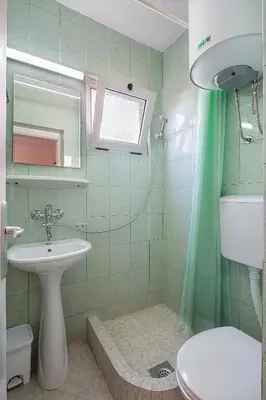 a bathroom with a sink and a toilet at Apartments Bloom Bečići in Becici