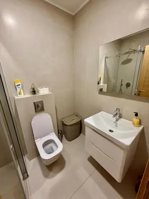 a white bathroom with a toilet and a sink at Apartmants City Love in Podgorica
