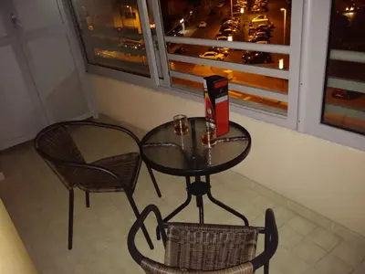 a table and a chair and a table and a window at City kvart na dan in Podgorica