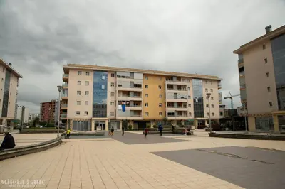 a large building with people walking in front of it at City kvart na dan in Podgorica