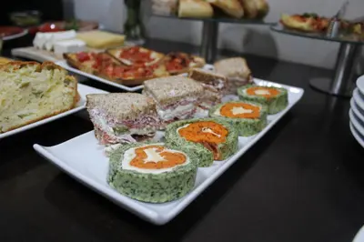a plate of food on a table with sushi at Hotel Alexandar Lux in Podgorica