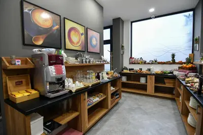 a bakery with a counter with food on it at Perla Residence Hotel & SPA in Podgorica