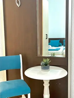 a table and two chairs in a room with a mirror at Monte Perla Residence in Sveti Stefan