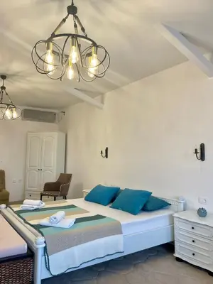 a bedroom with a large bed with blue pillows at Monte Perla Residence in Sveti Stefan